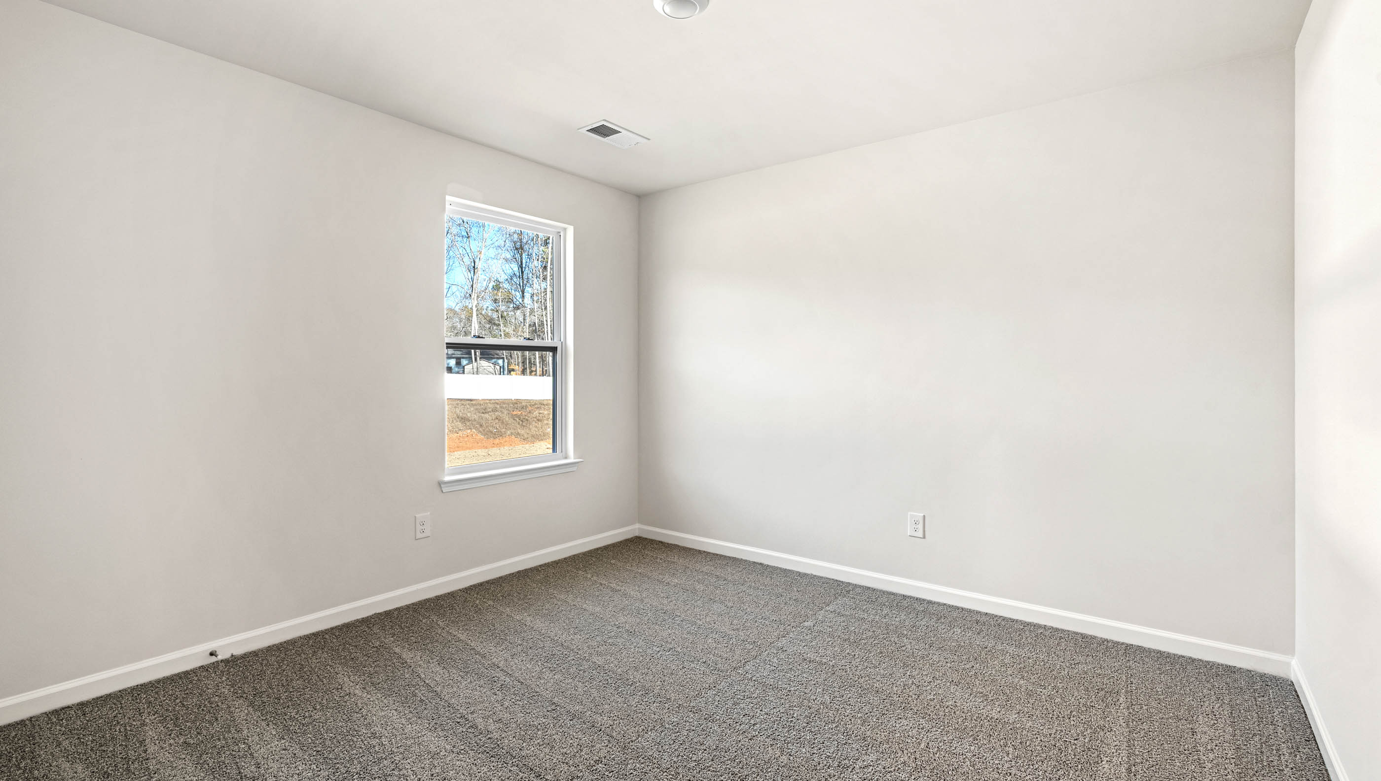 Bedroom with carpet and window.
