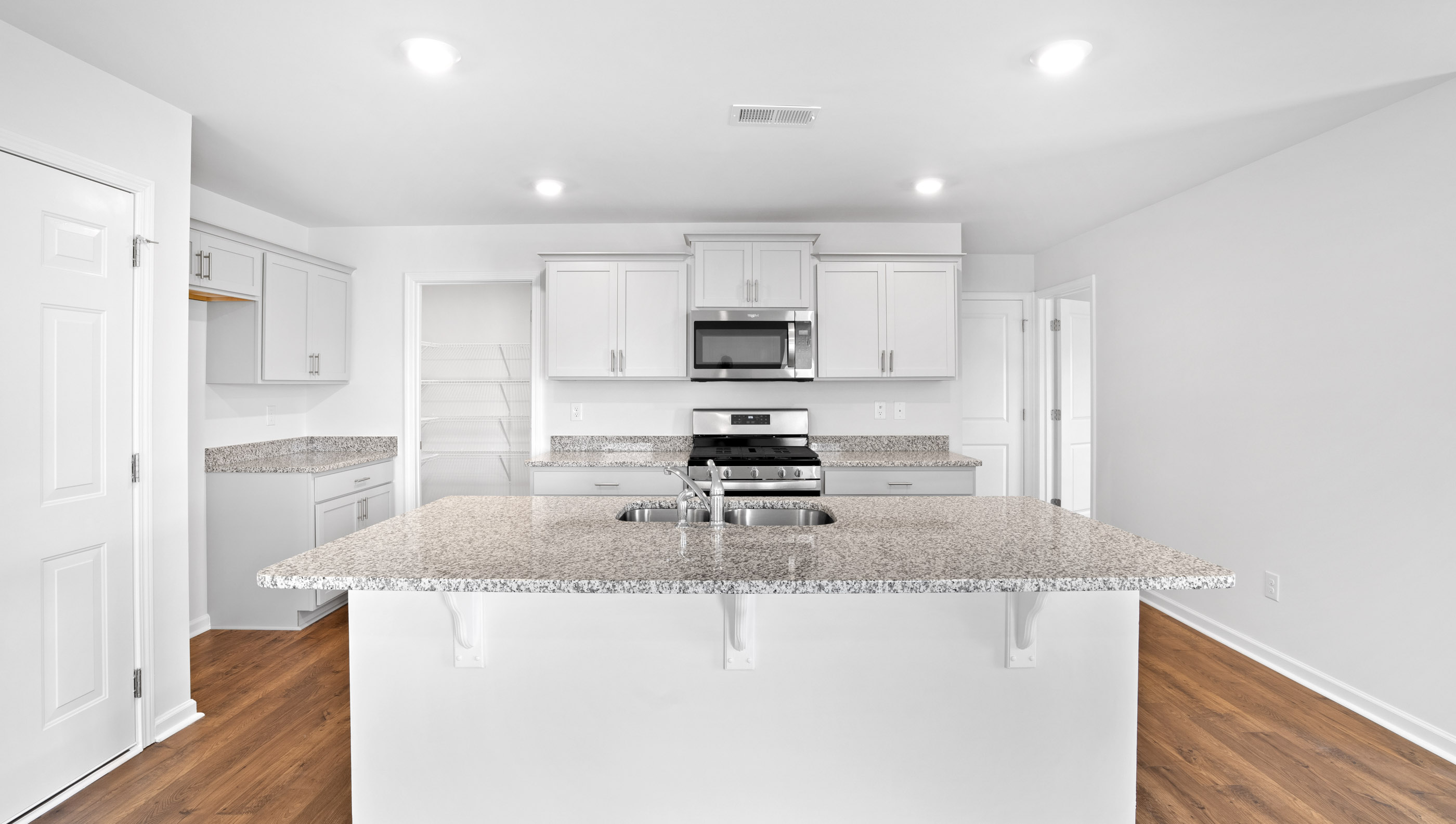 Kitchen and island with granite countertops.