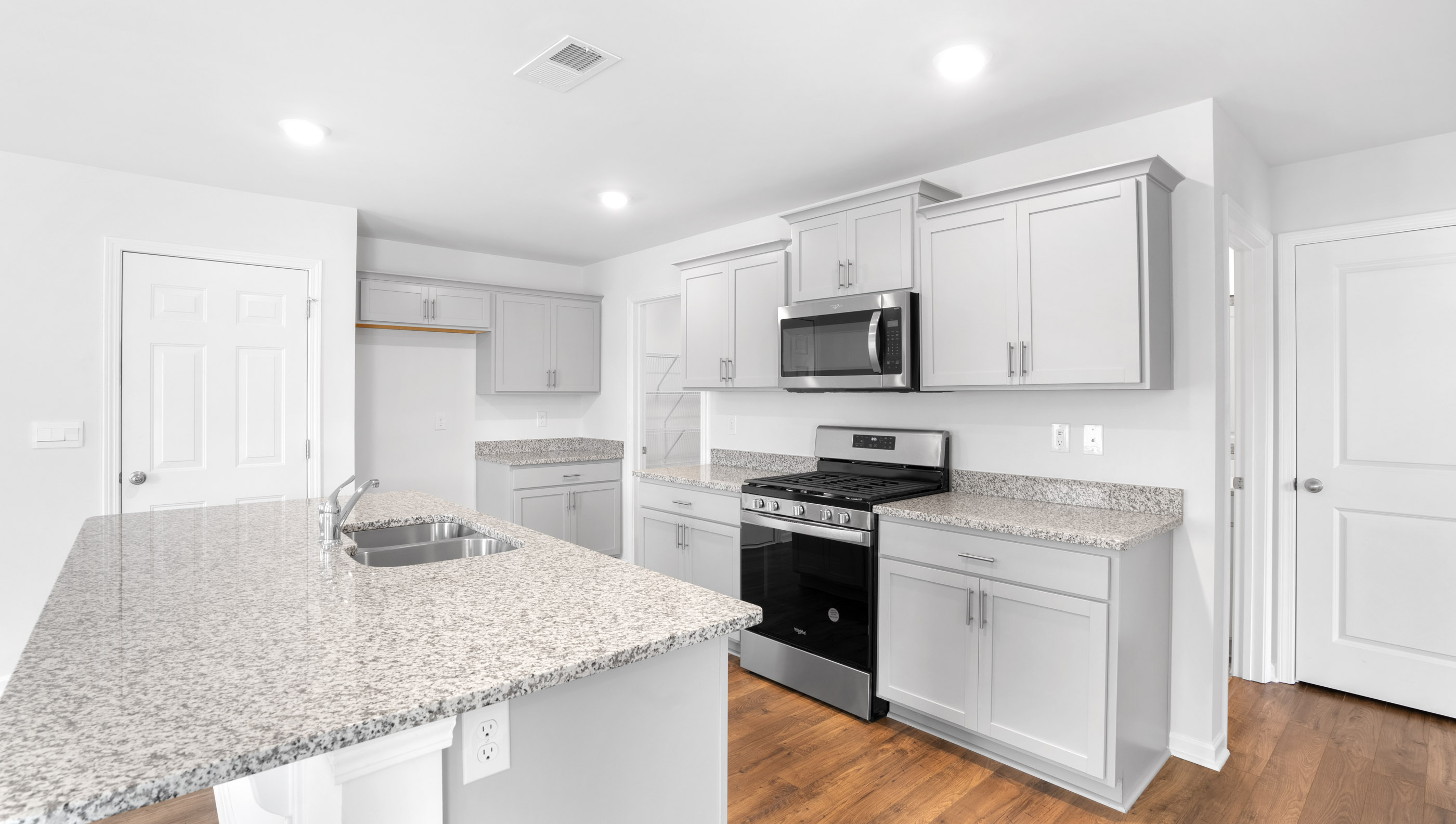 Kitchen and island with granite countertops.