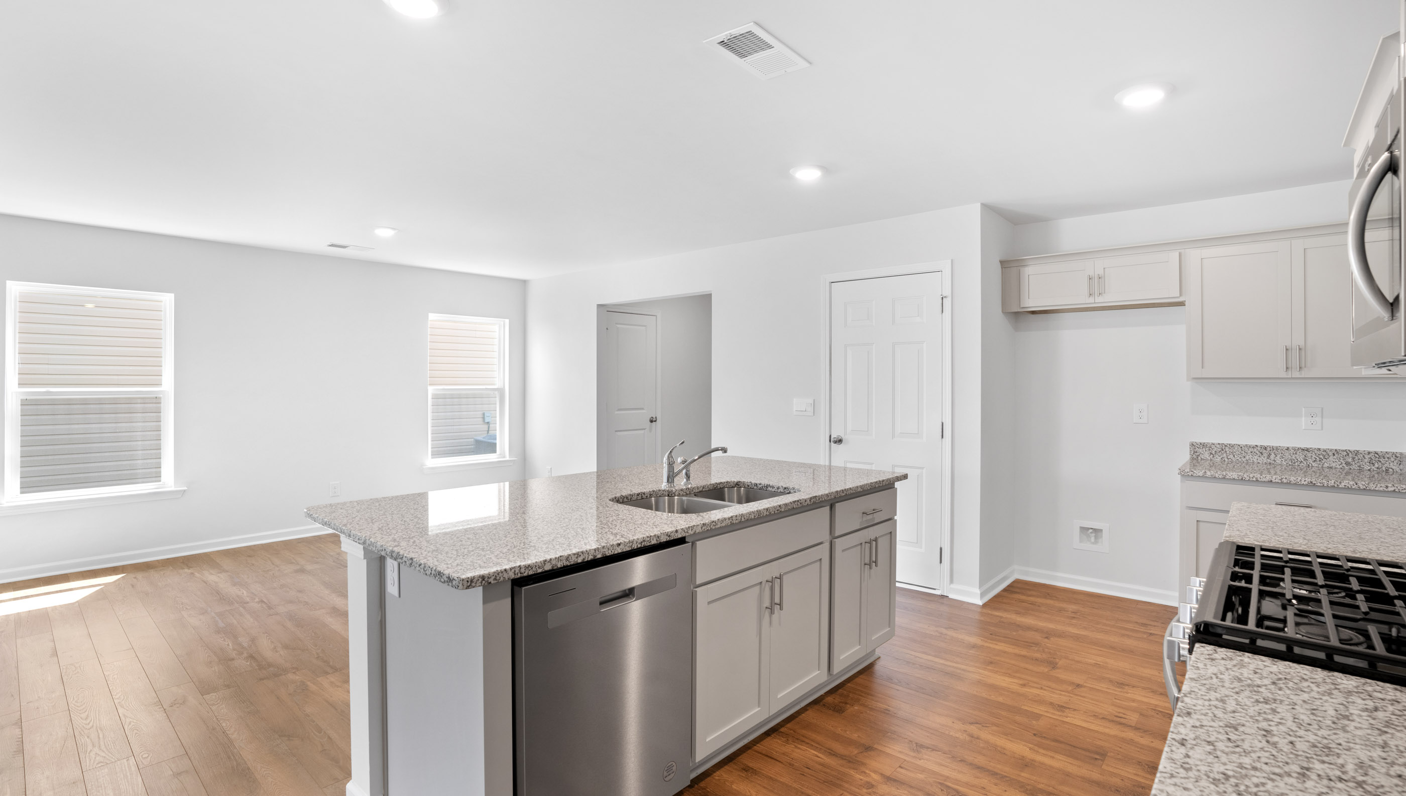 Kitchen and island with granite countertops.