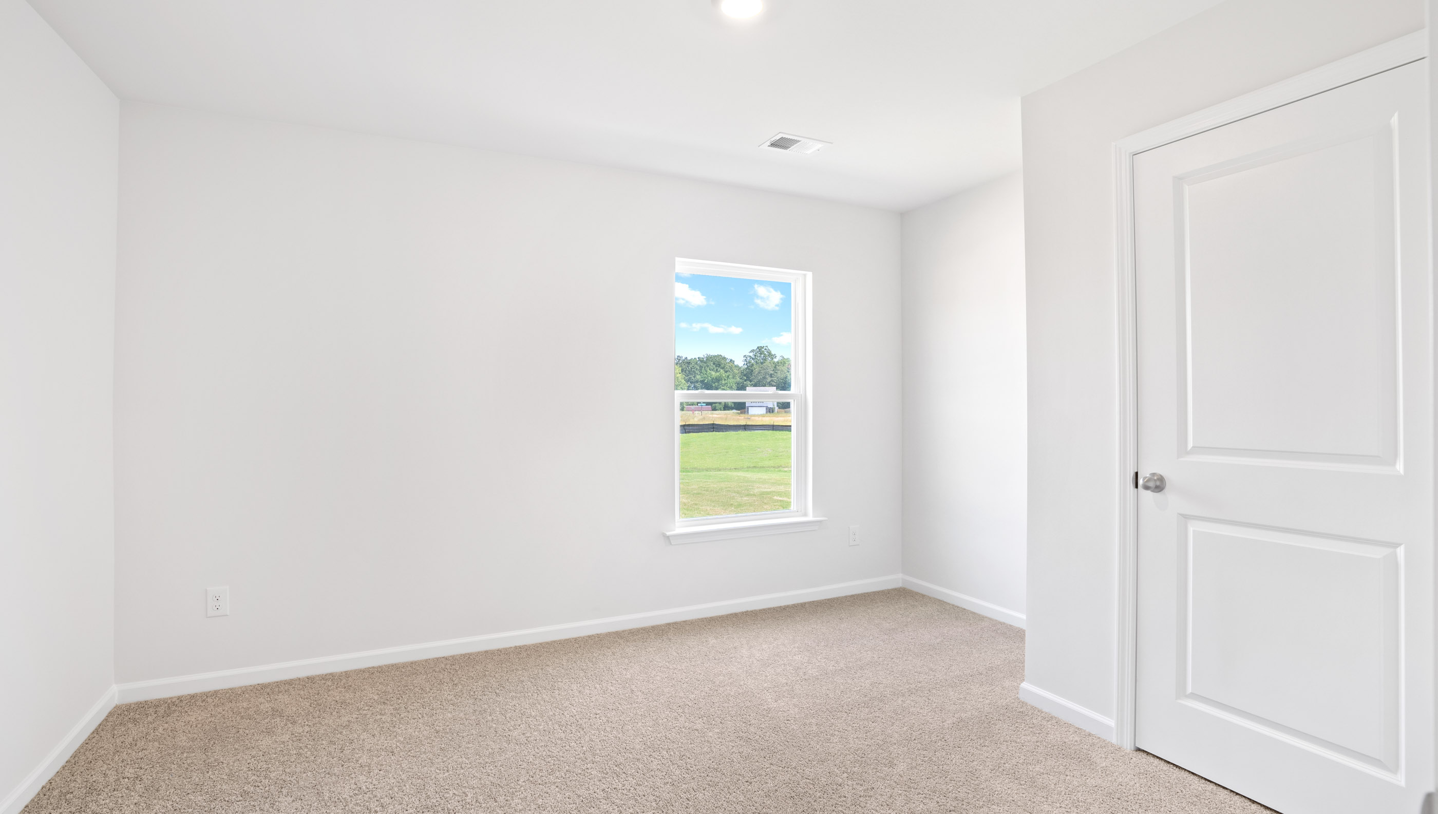Bedroom with carpet and window.