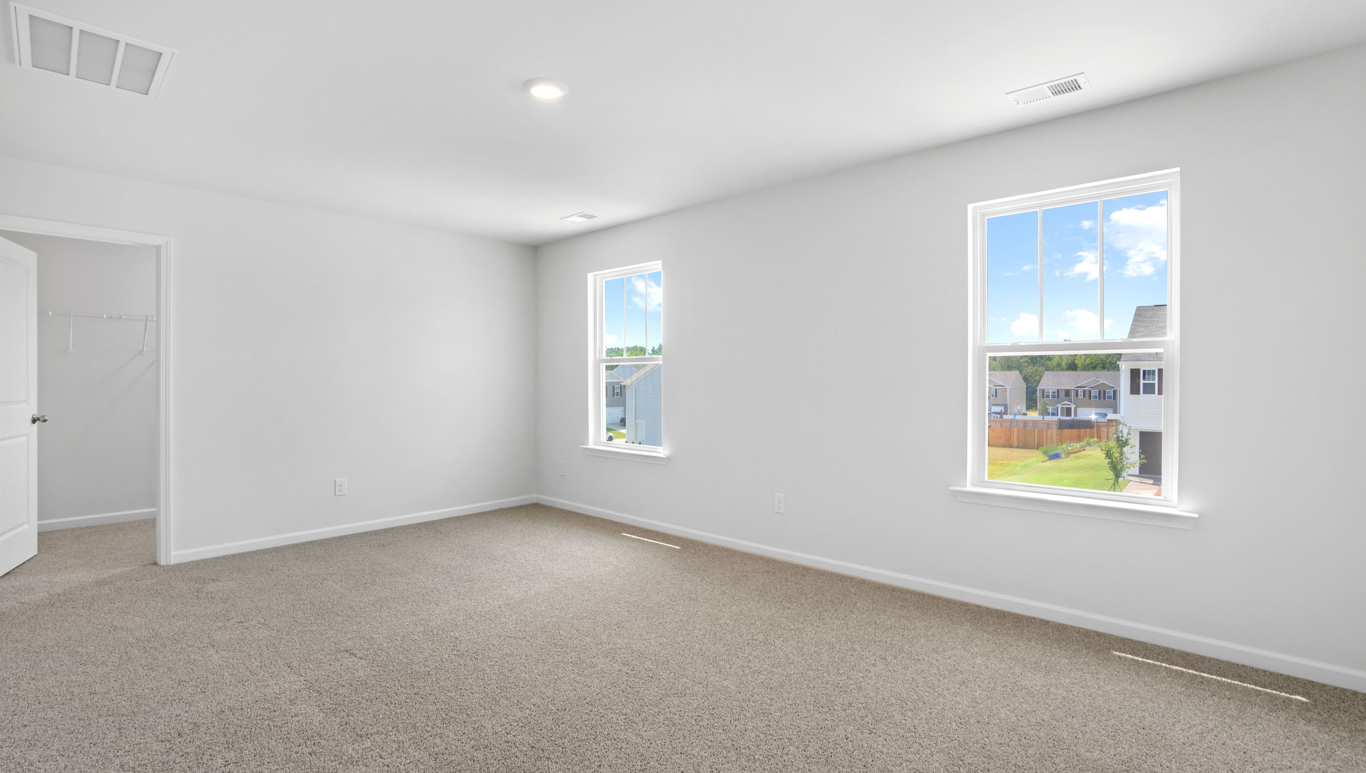 Bedroom with carpet and window.