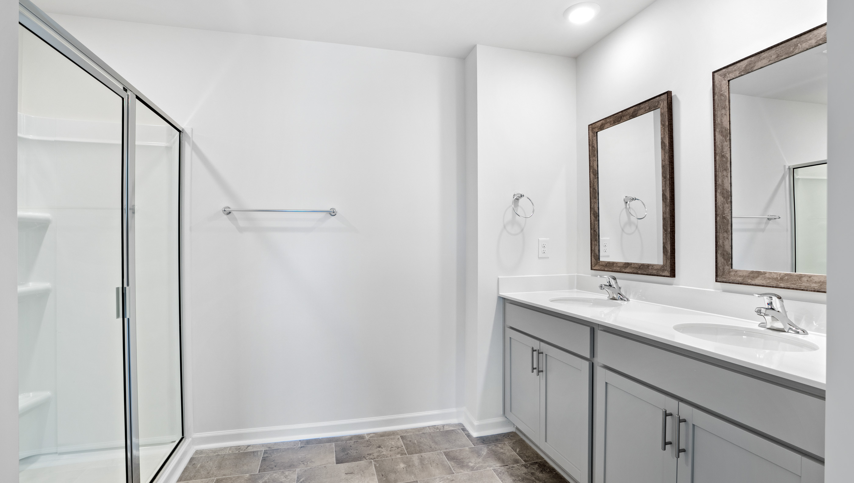 Bathroom with vanity and walk in shower.