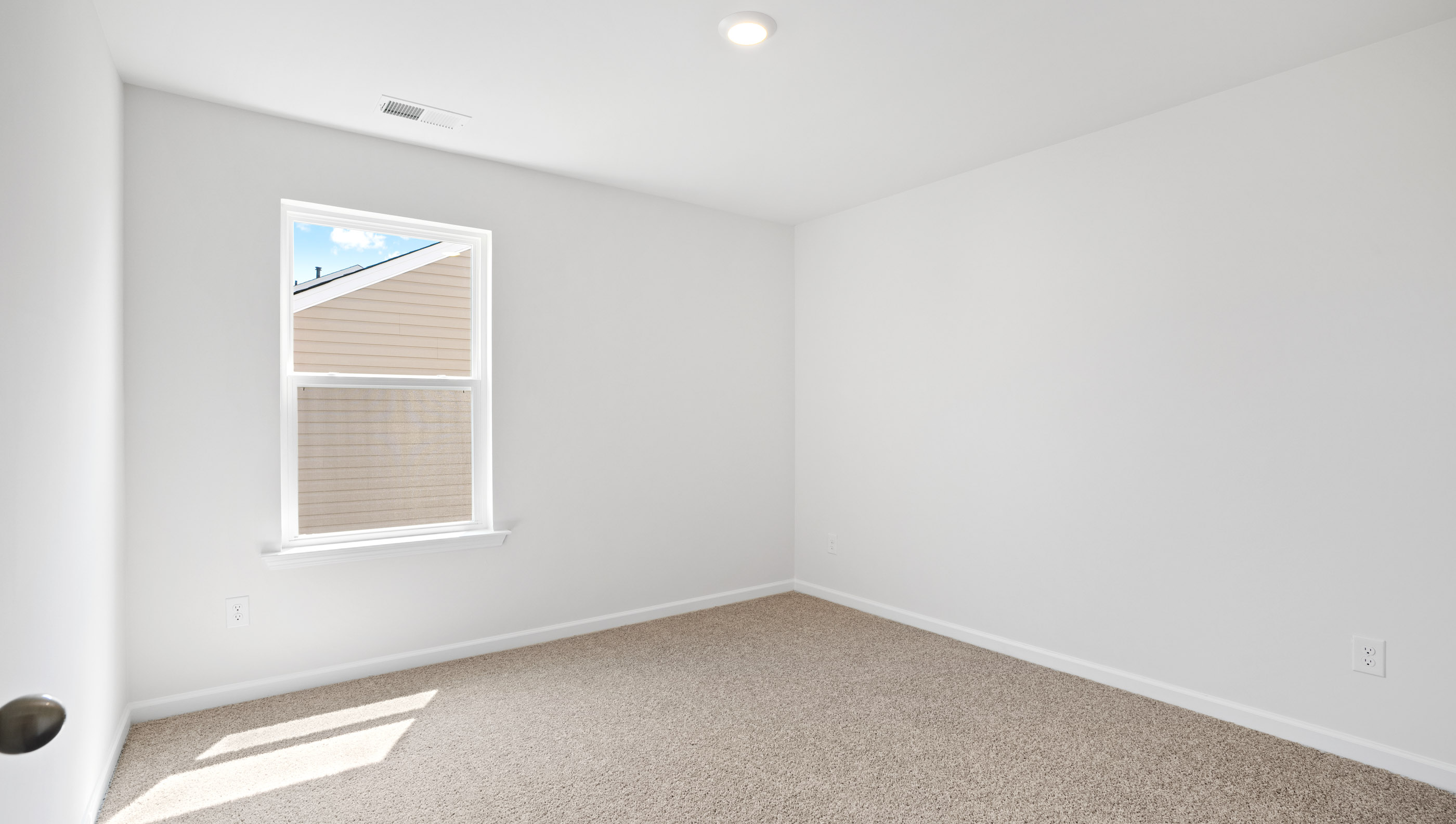 Bedroom with carpet and window.
