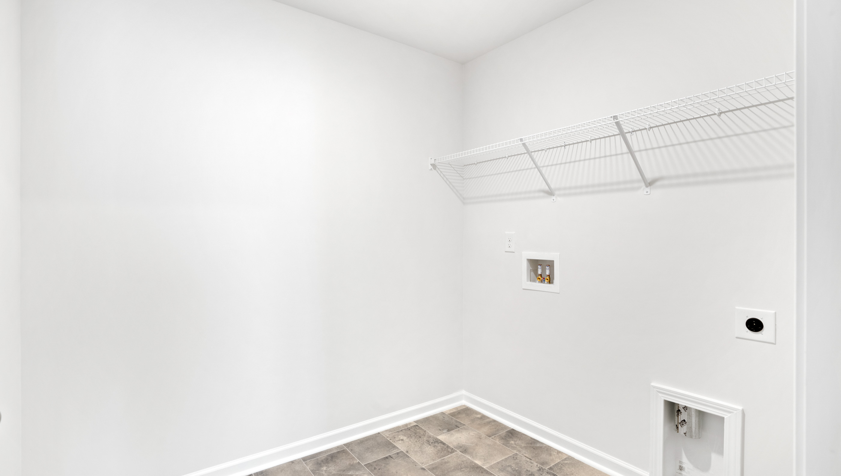 Walk in laundry with shelves.