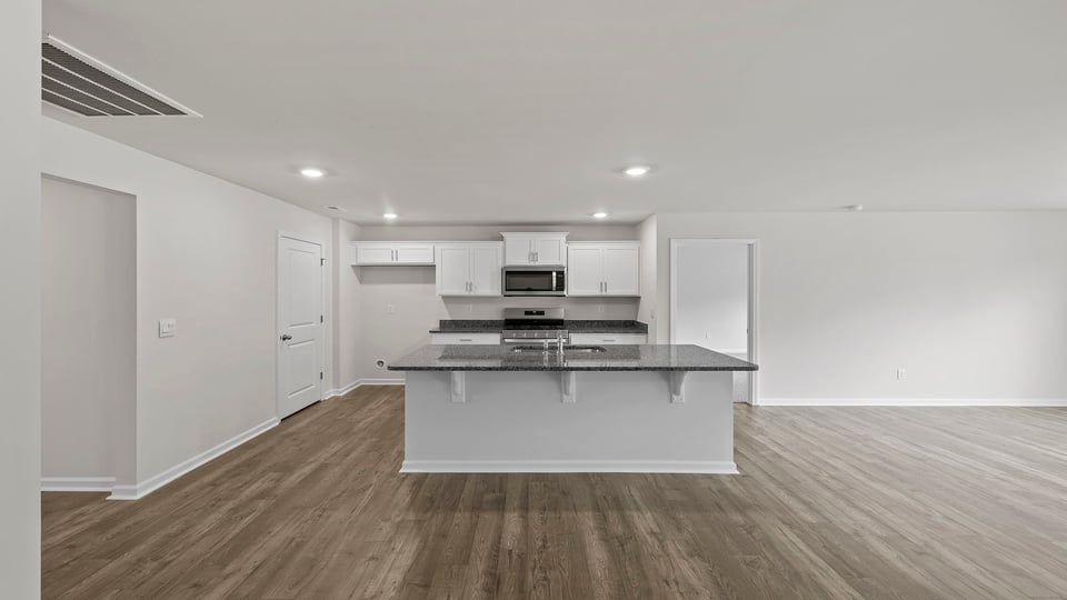 Kitchen and island with granite countertops.