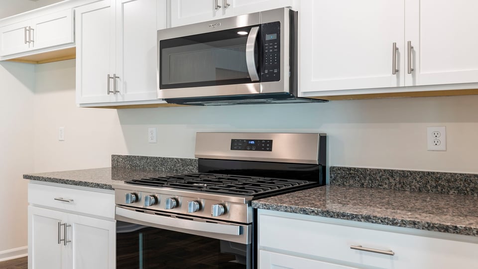 Kitchen with granite countertops and stainless steel appliances.