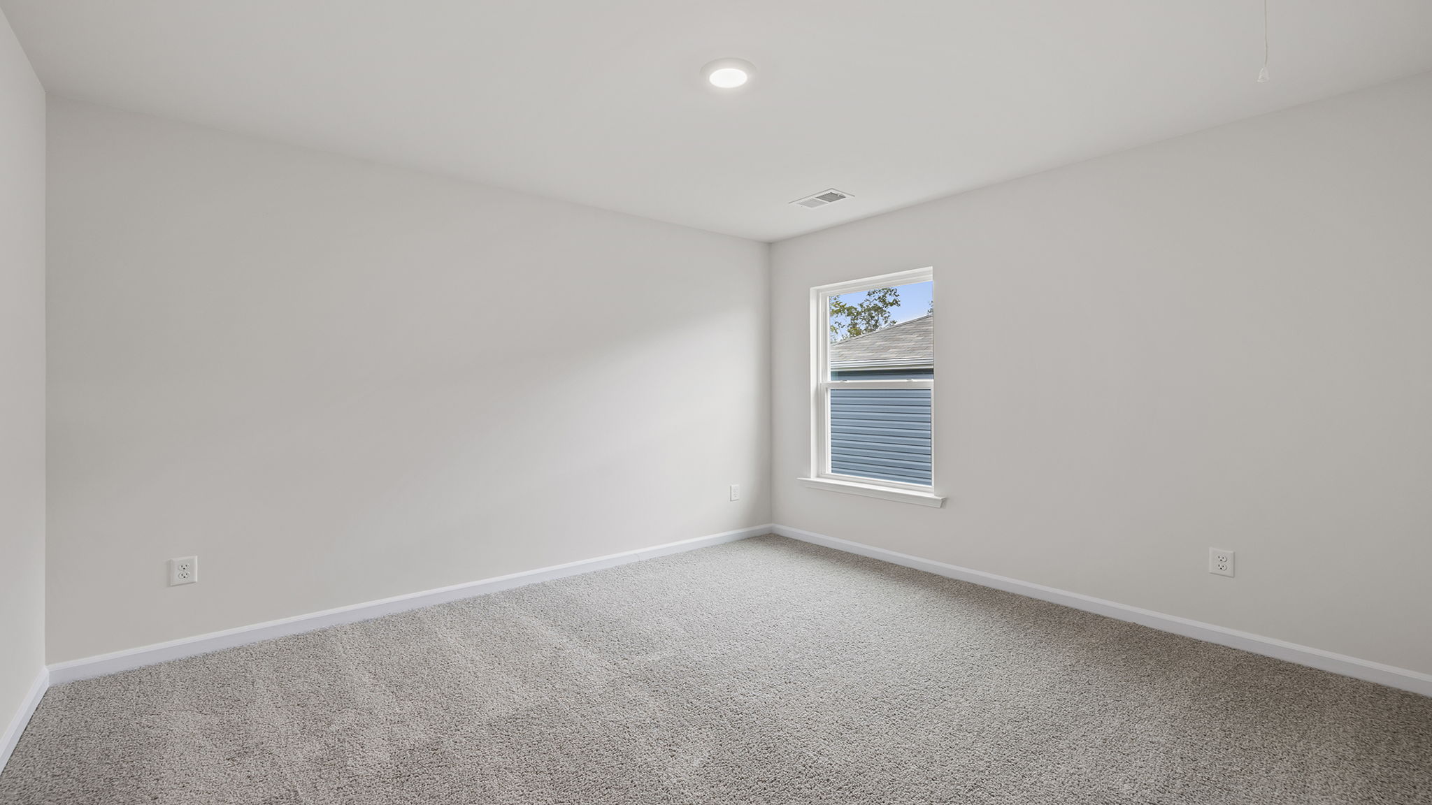 Bedroom with carpet and window.