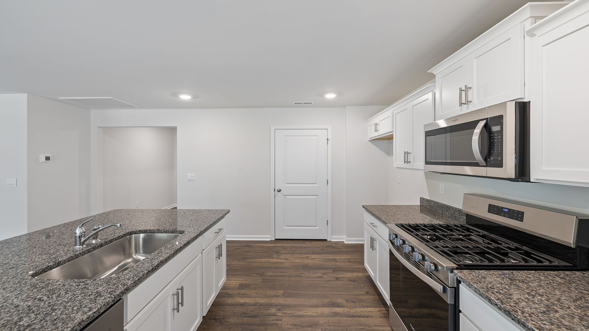 Kitchen and island with granite countertops.