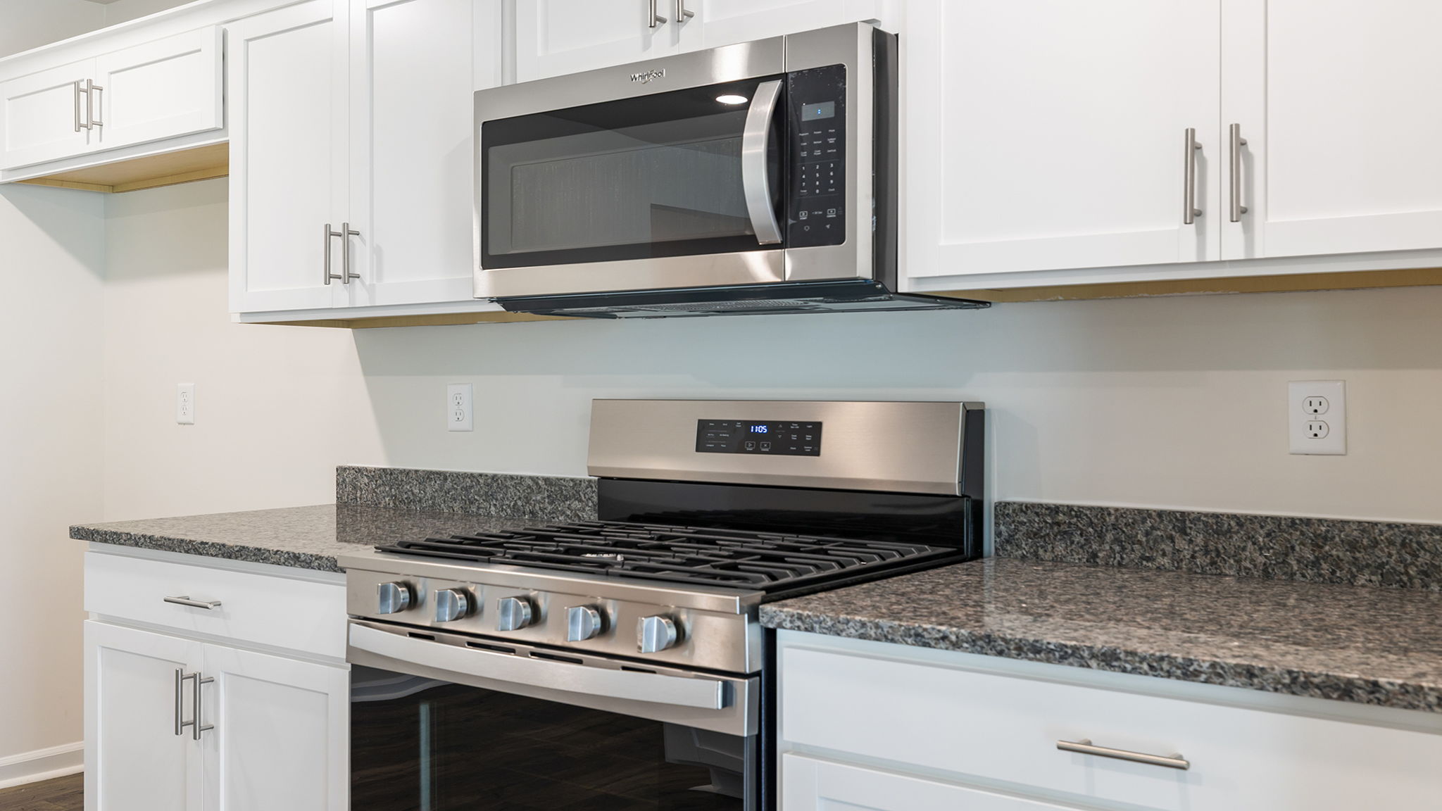 Kitchen with granite countertops and stainless steel appliances.