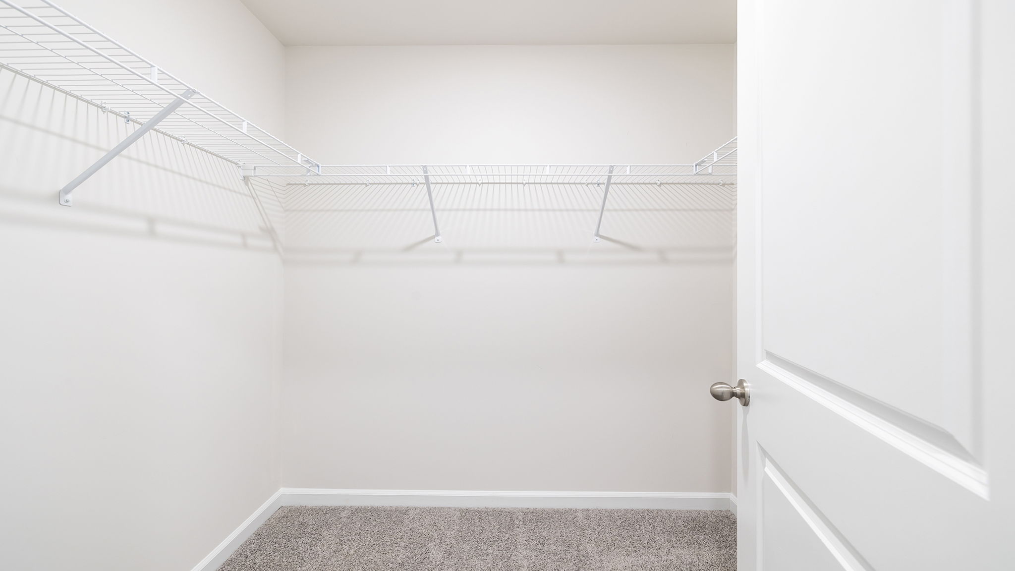 Walk in closet with shelves.