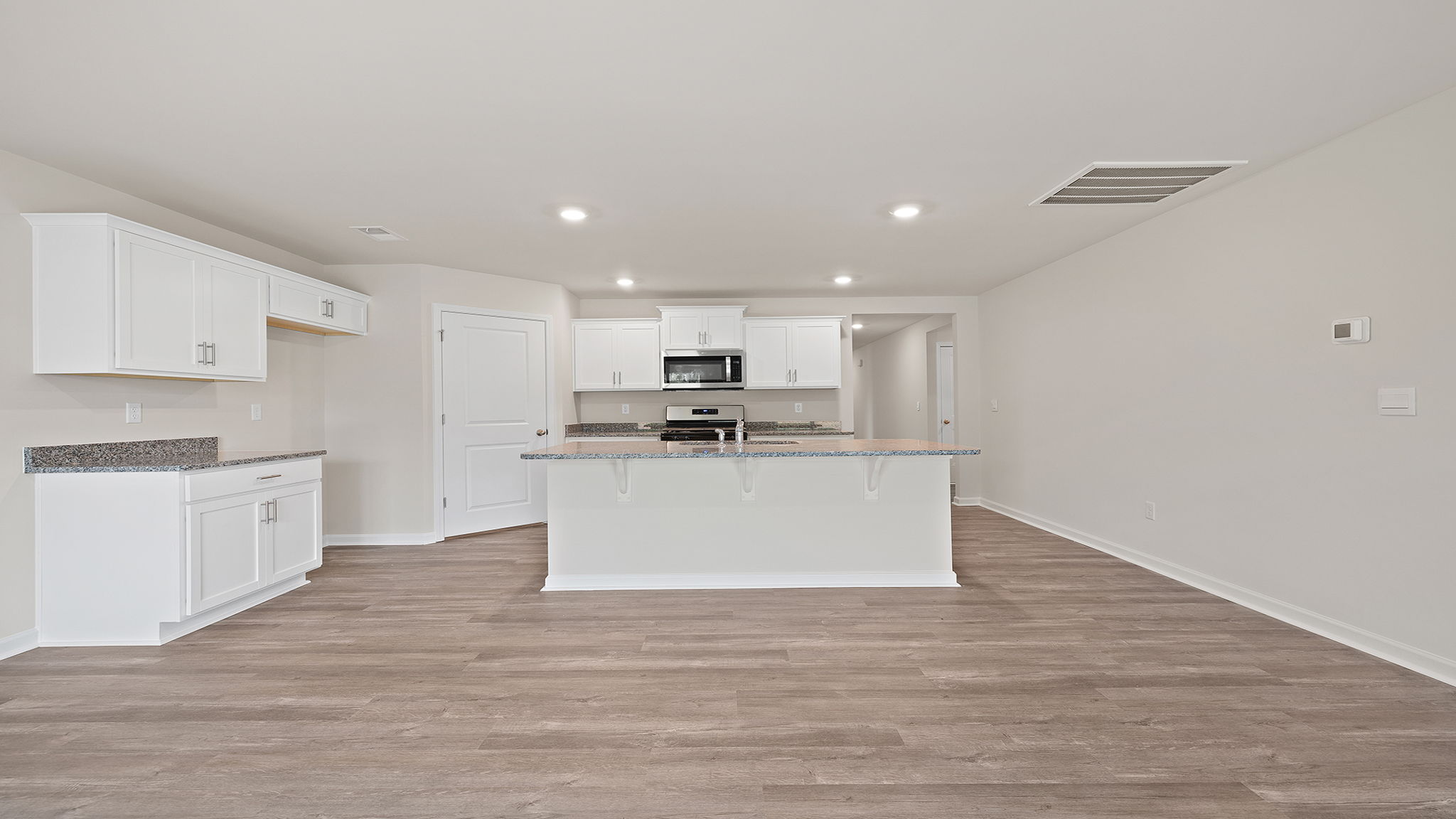 Kitchen with island and stainless steel appliances.