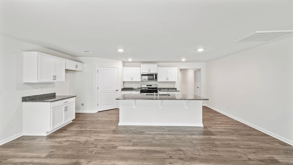 Kitchen and island with granite countertops.