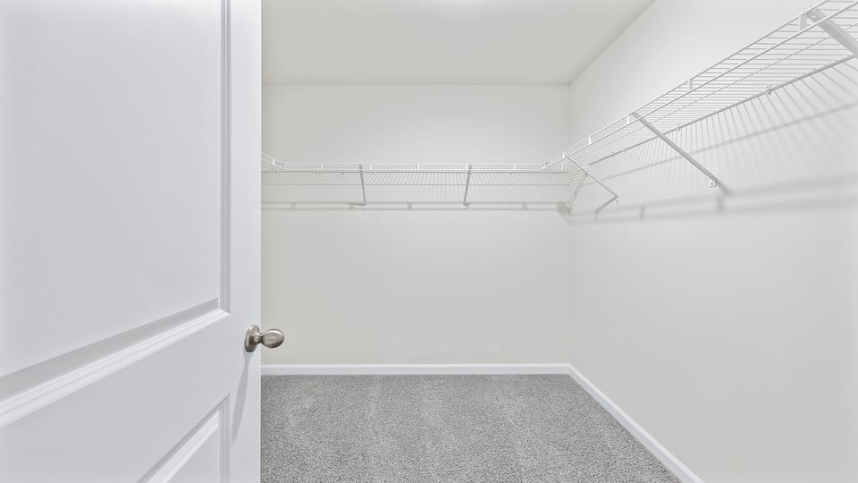 Walk in closet with shelves.