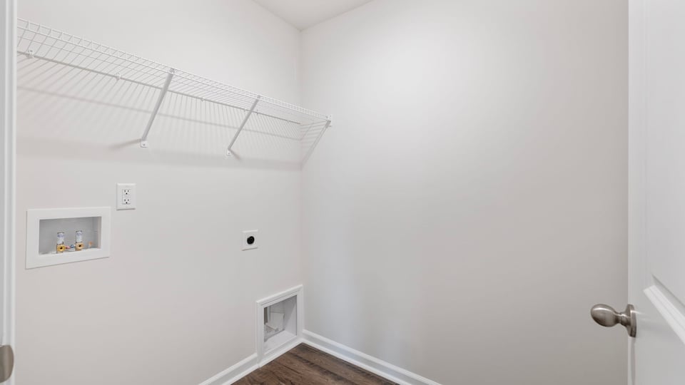 Walk in laundry with shelf.