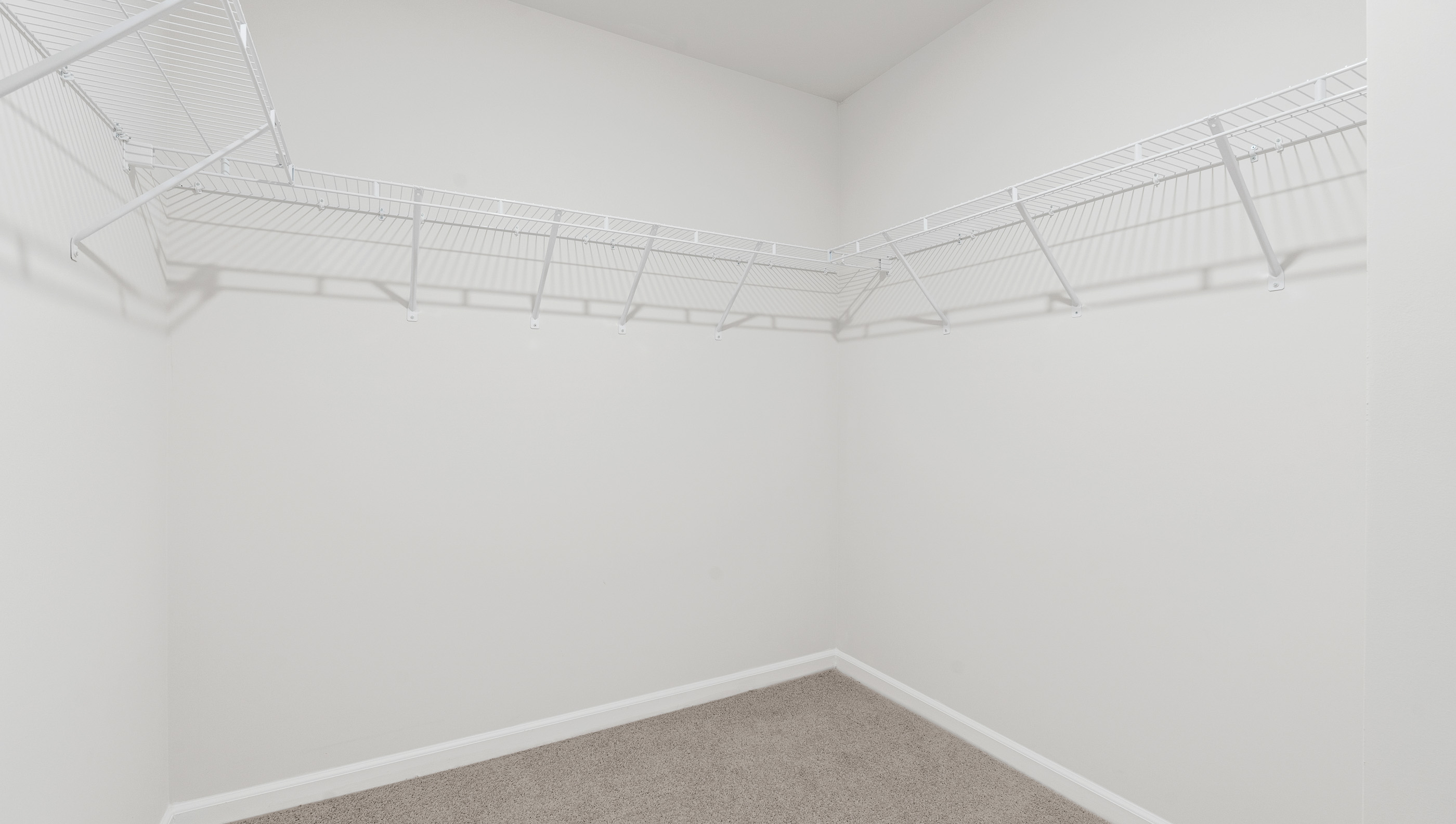 Walk in closet with shelves.