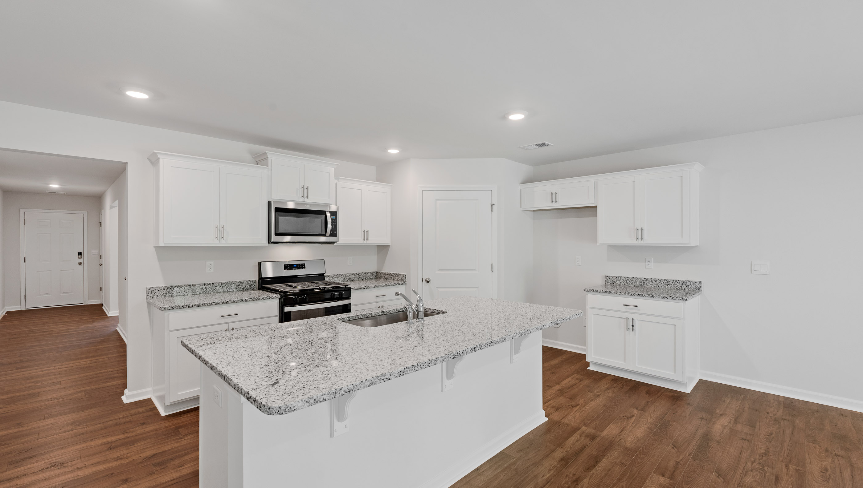 Kitchen and island with granite countertops.