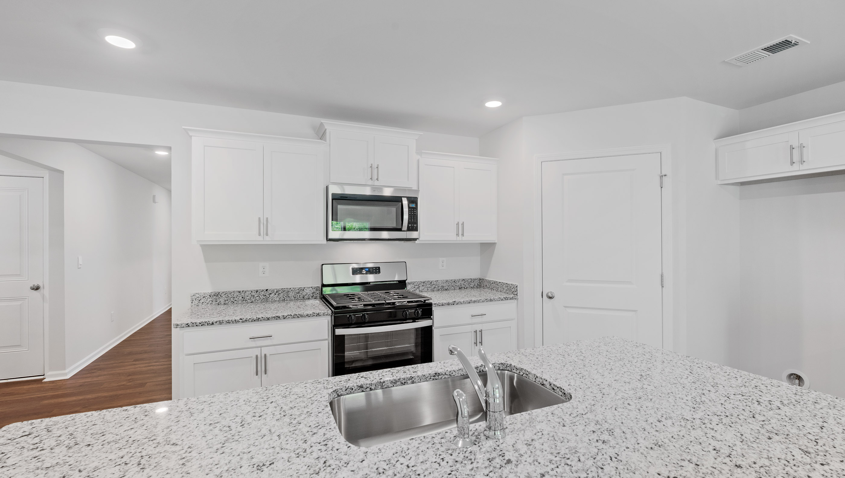 Kitchen and island with granite countertops.