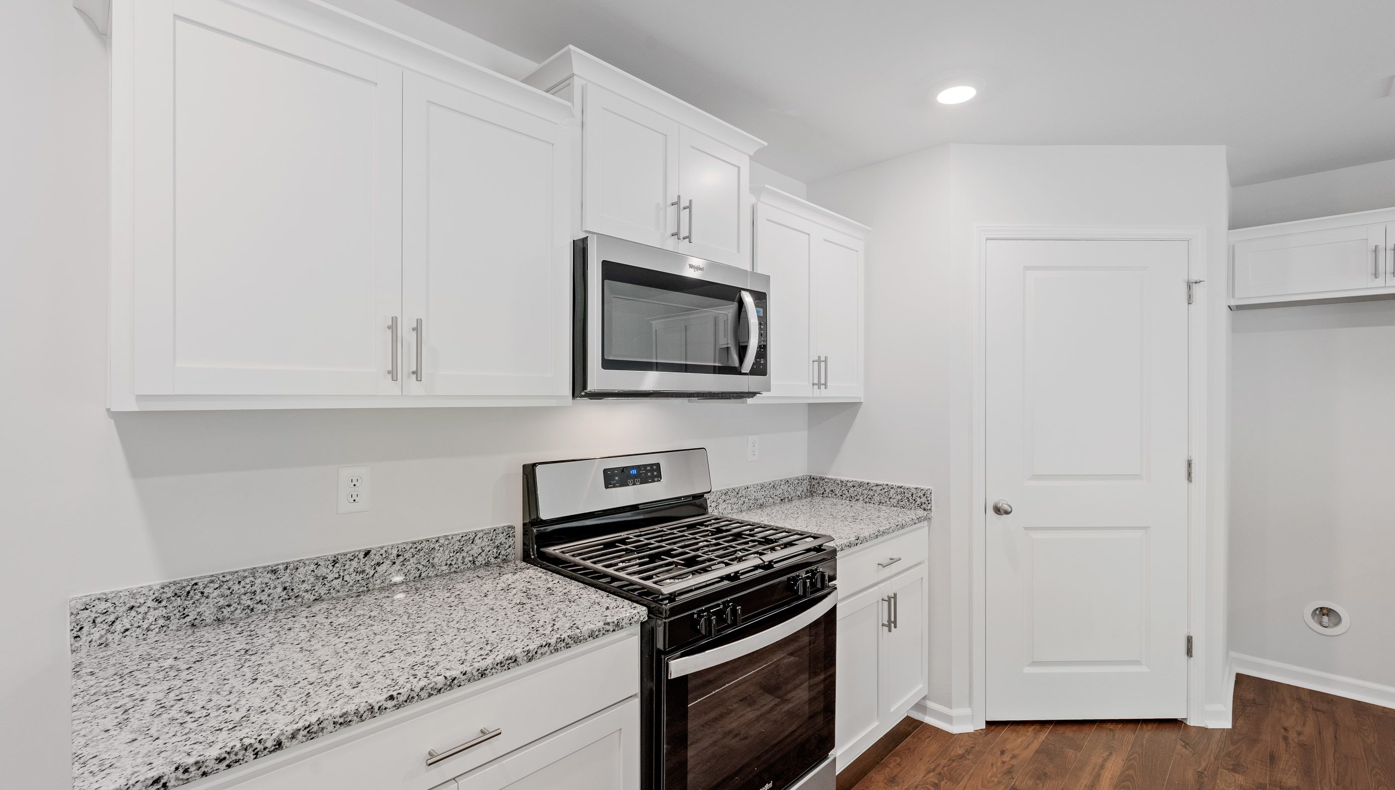 Kitchen with granite countertops and stainless steel appliances.
