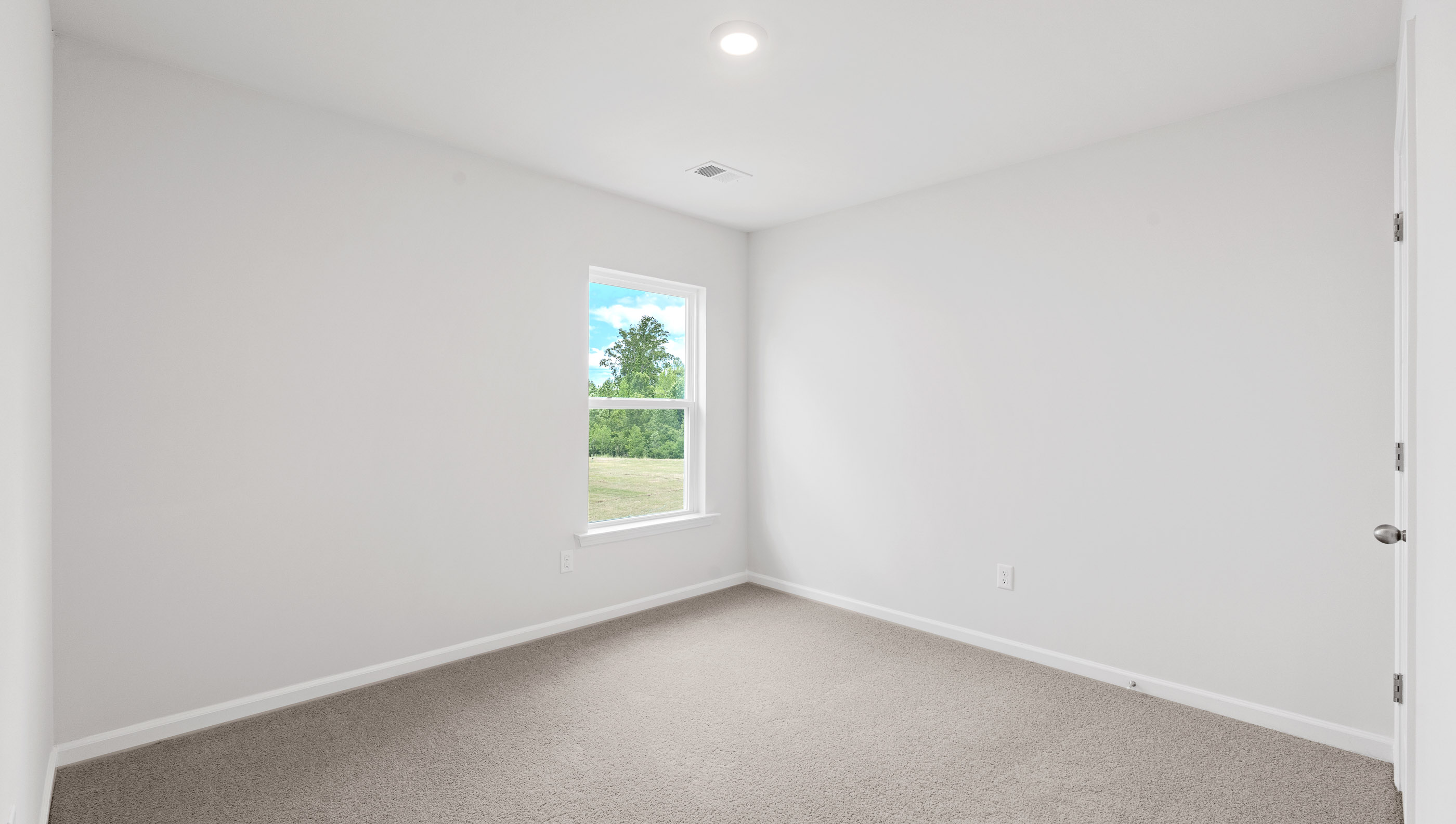 Bedroom with carpet and windows.