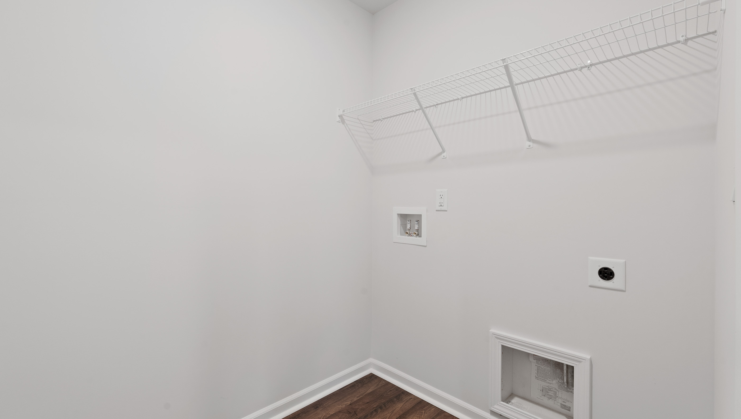 Walk in laundry with shelves.