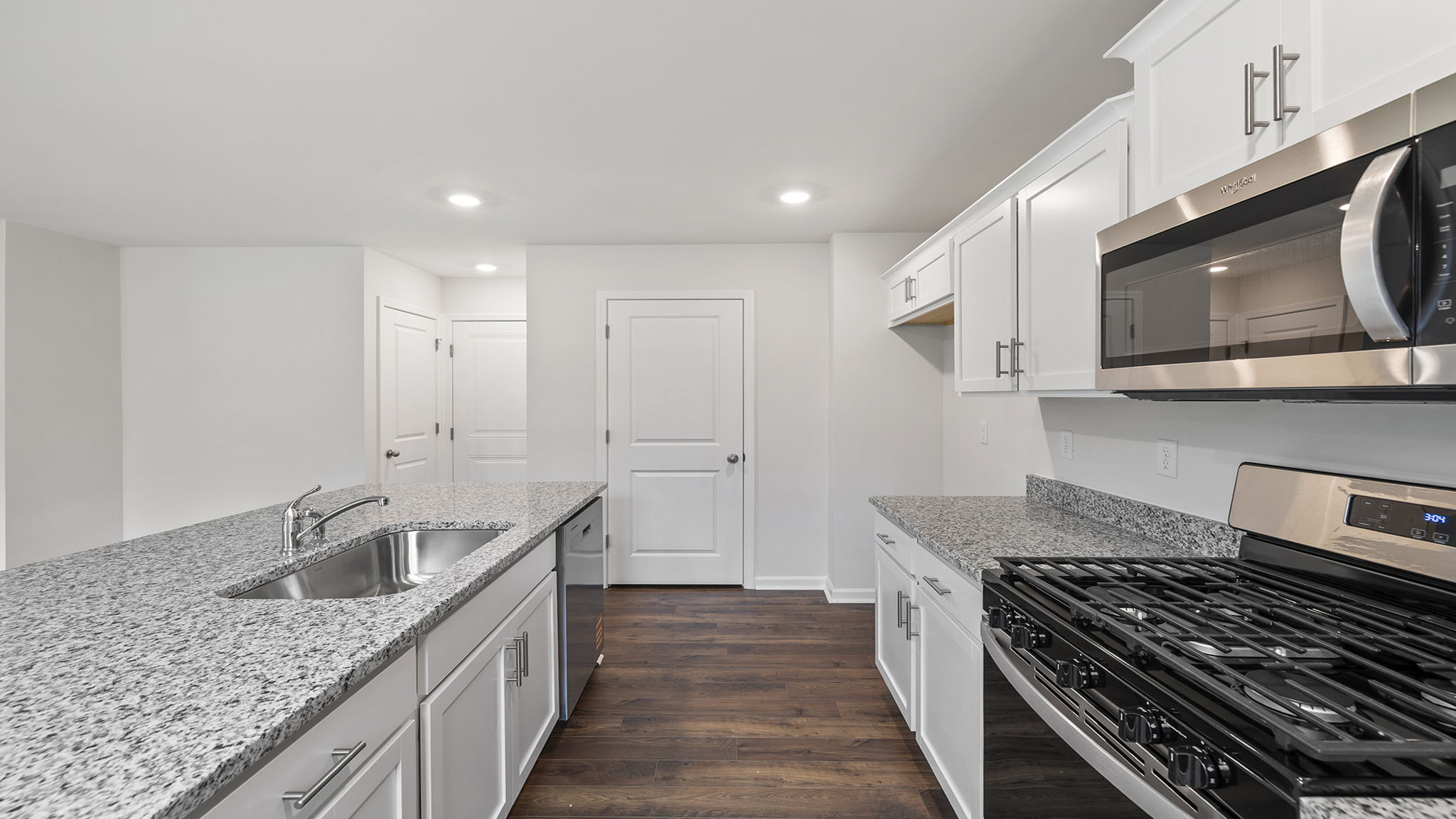 Kitchen and island with stainless steel appliances.