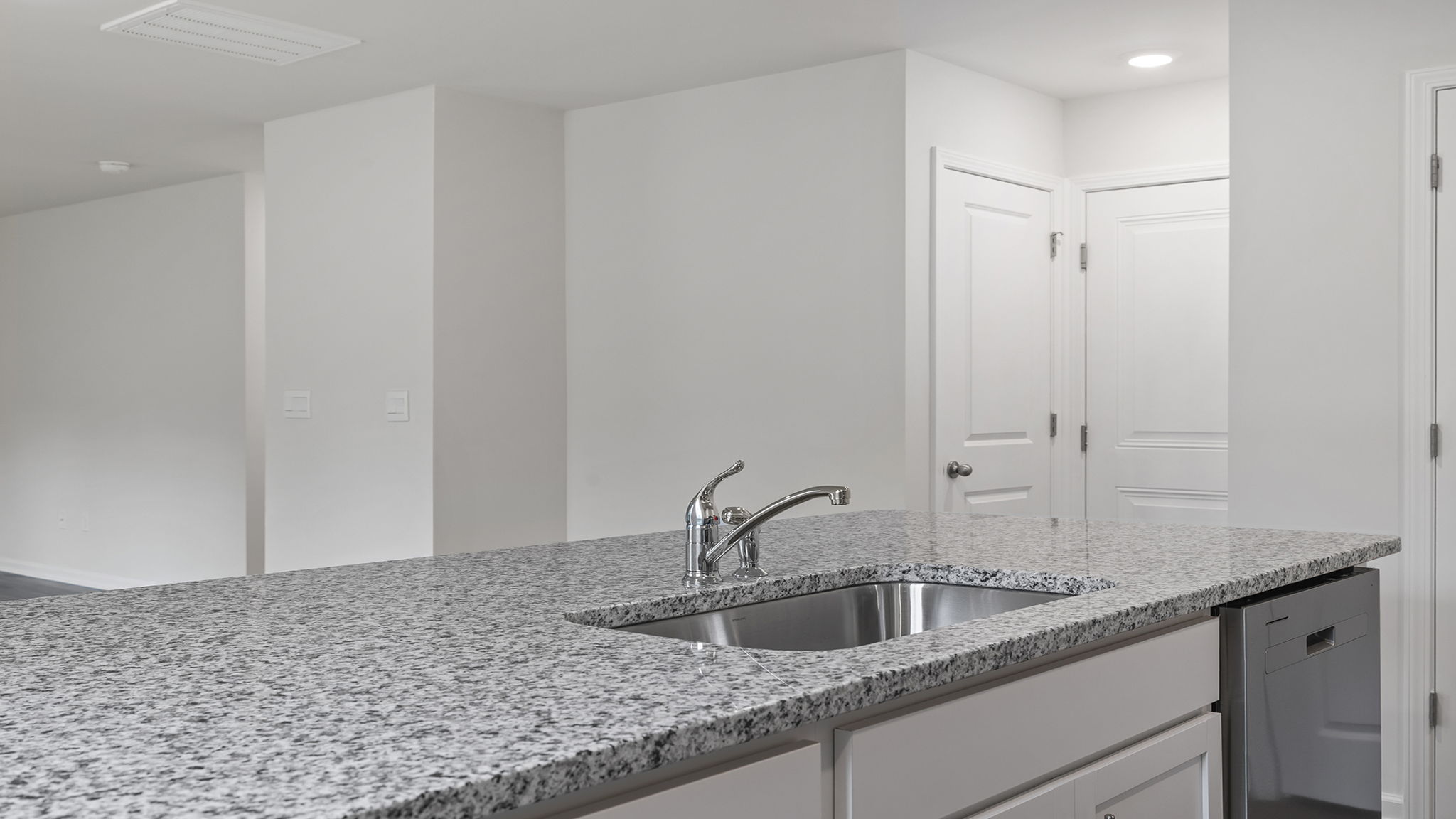 Kitchen and island with stainless steel appliances.