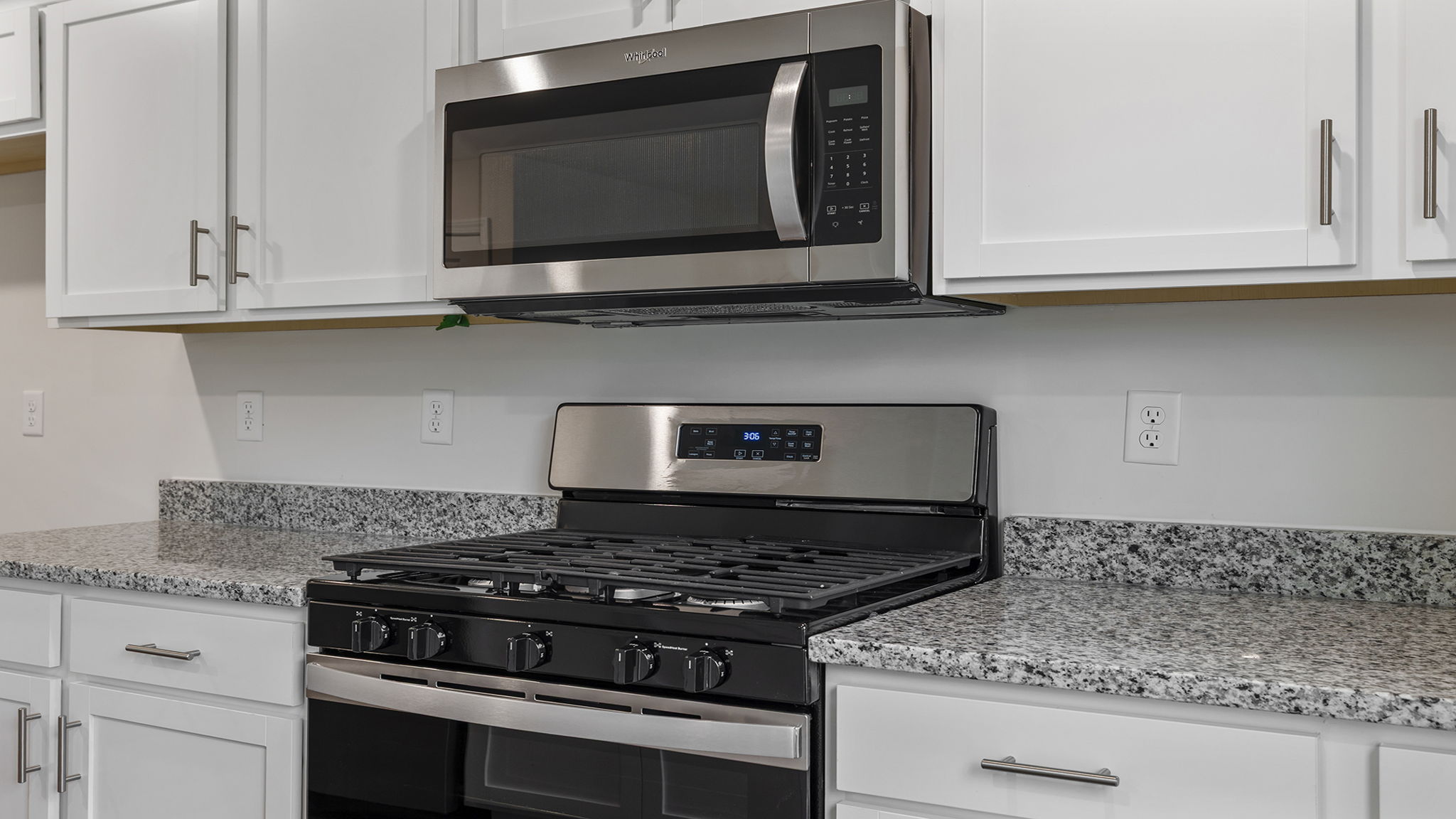 Kitchen and island with stainless steel appliances.