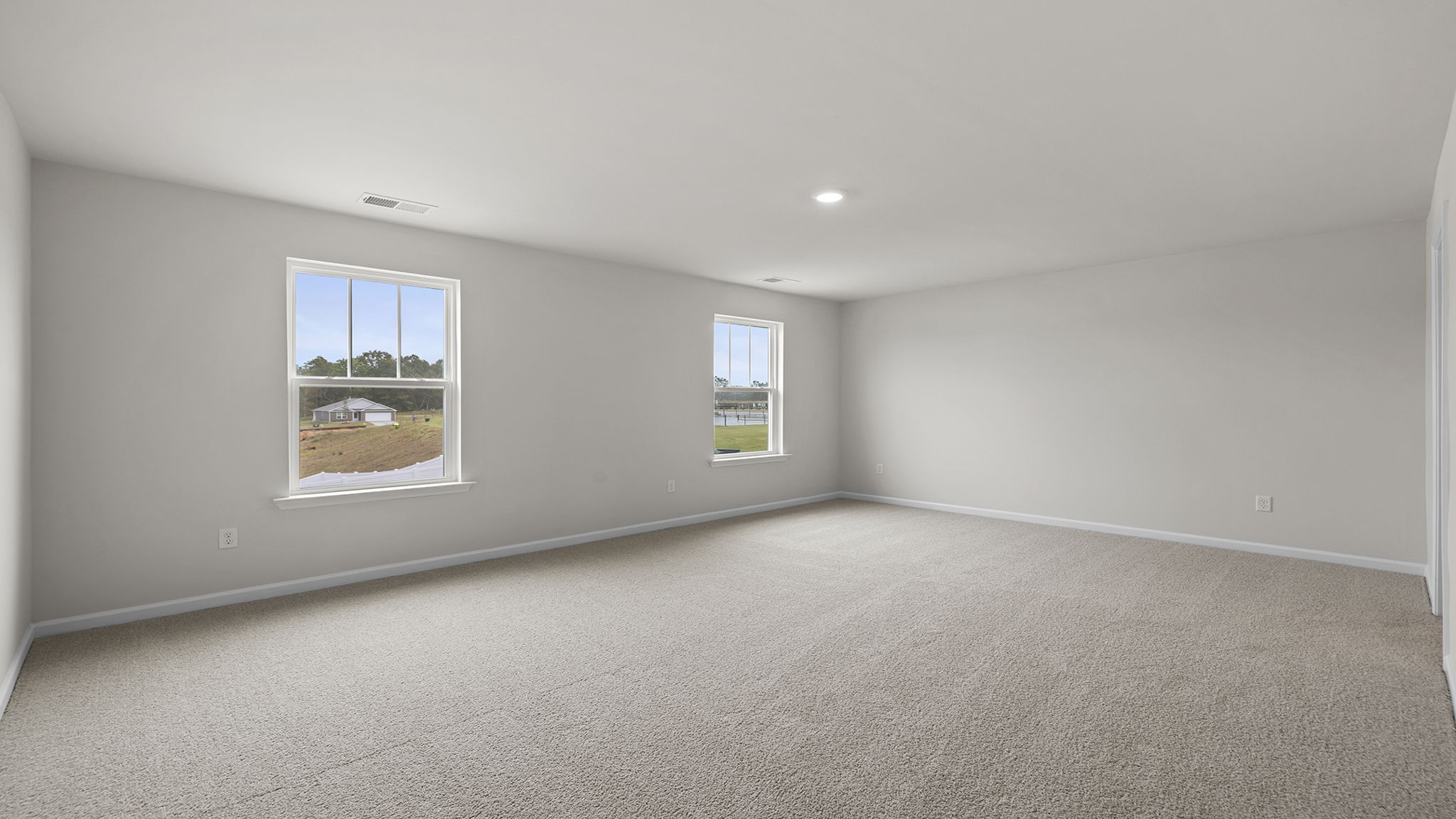 Bedroom with carpet and window.