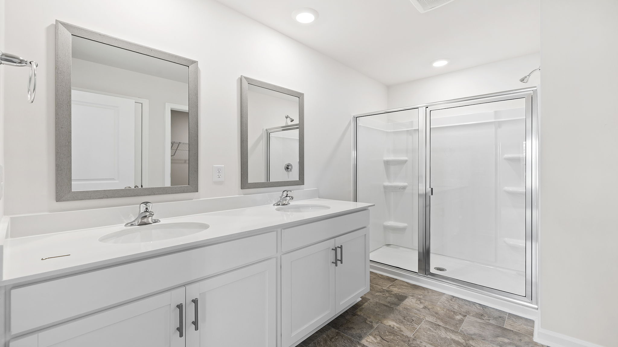 Bathroom with double vanity sink and shower.