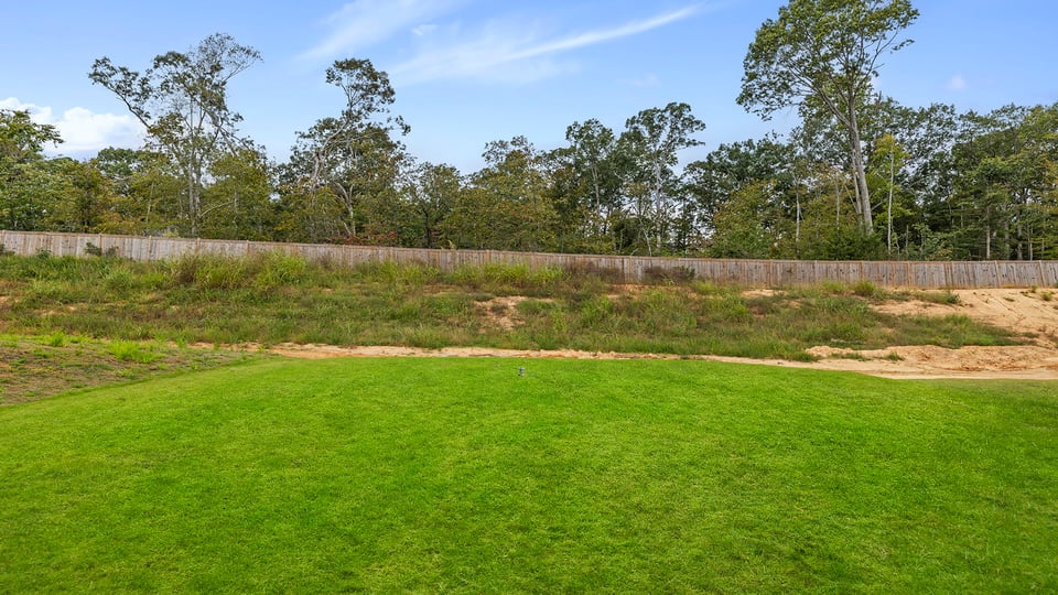 Exterior of home with large backyard.