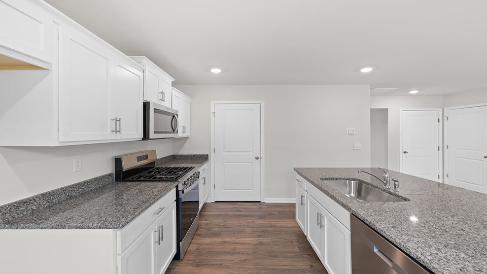 Kitchen and island with granite countertops.