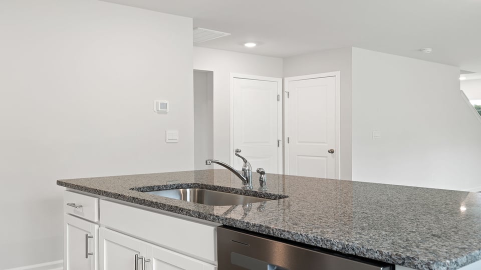 Kitchen and island with granite countertops.