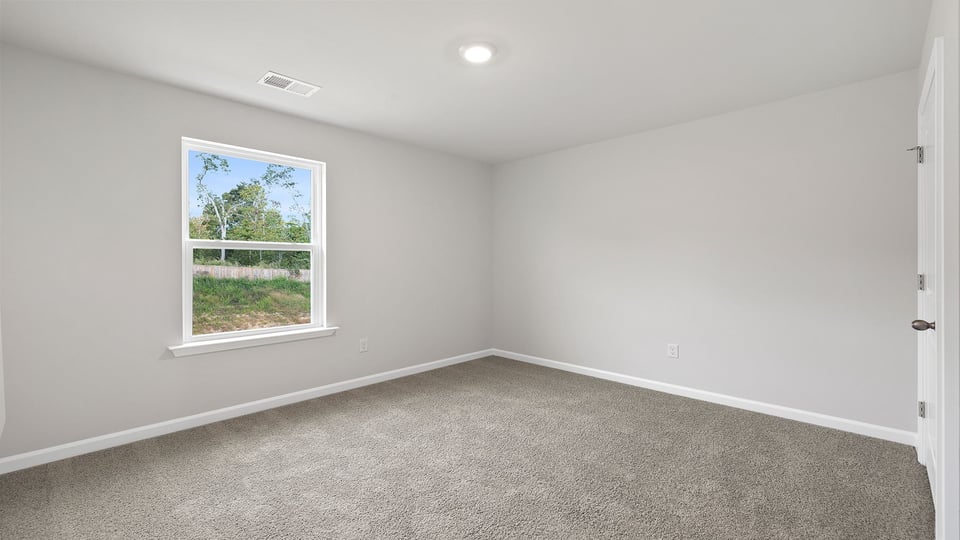 Bedroom with carpet and window.