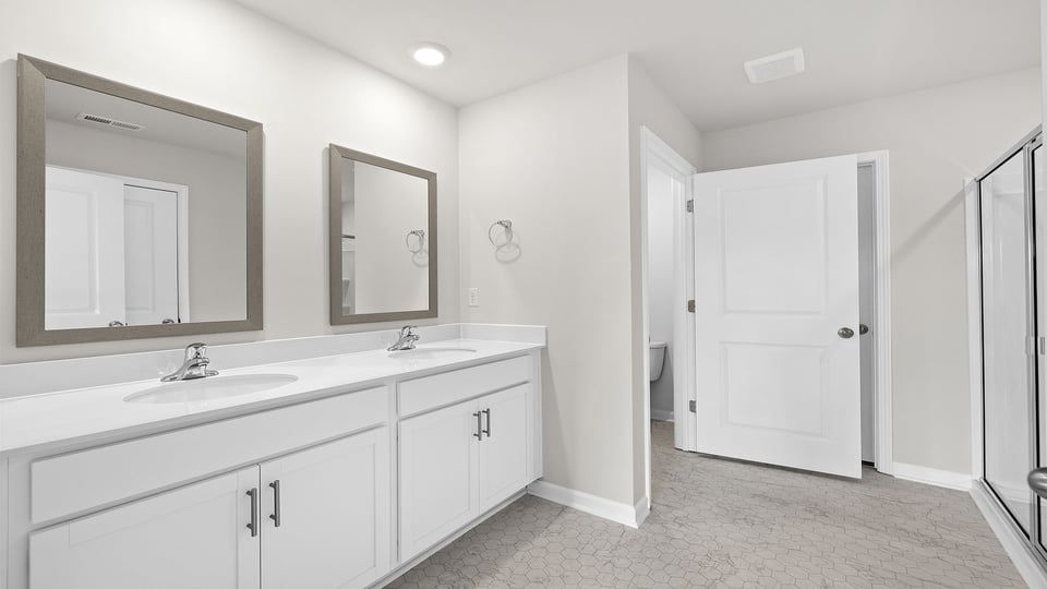 Bathroom with dual vanity and walk in shower.