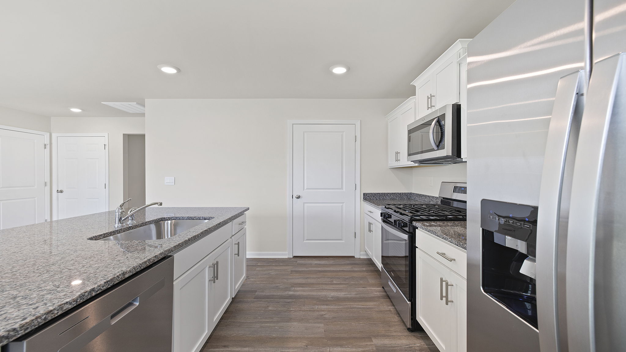 Kitchen and island with granite counter tops.