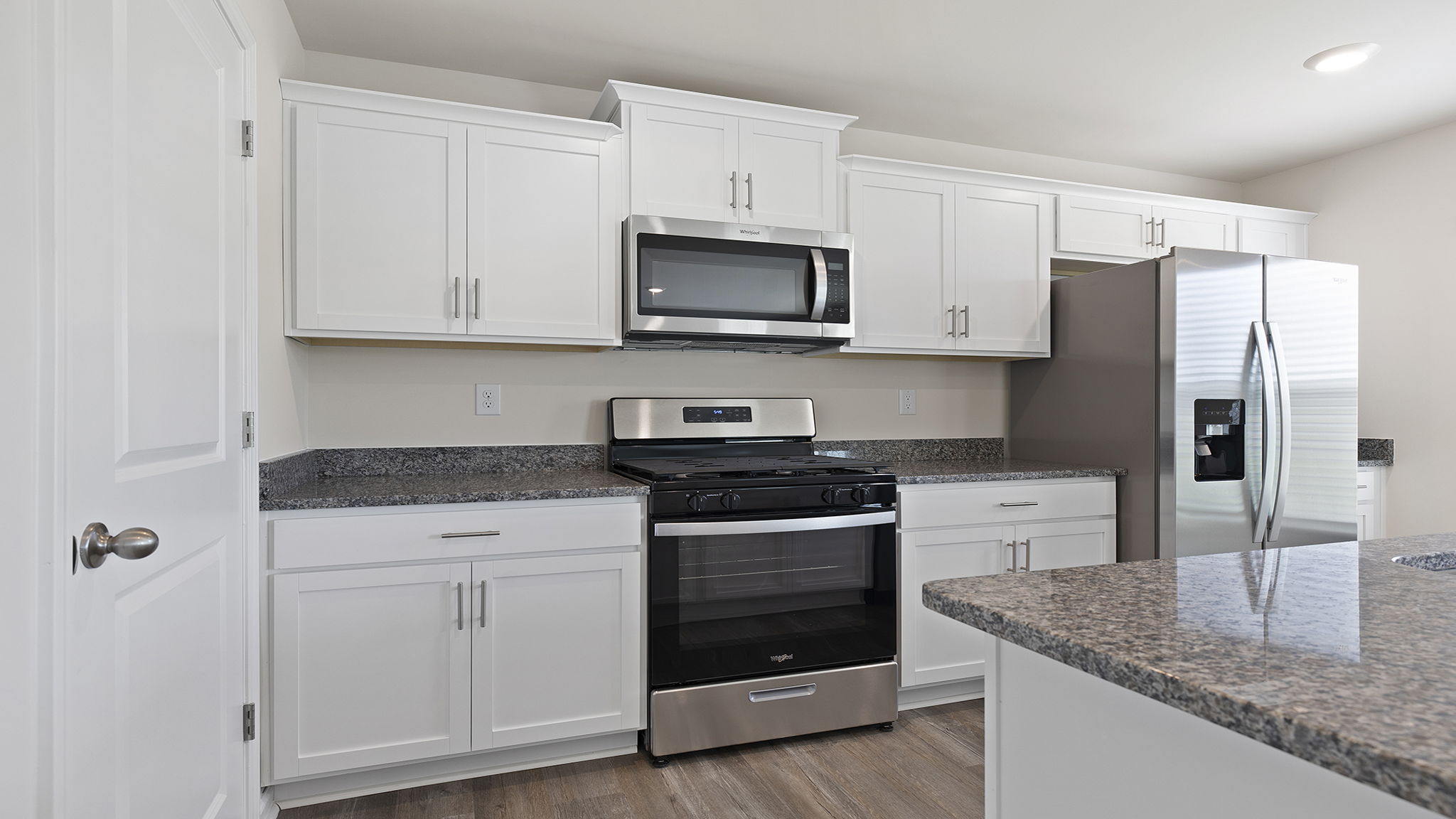 Kitchen and island with granite counter tops.