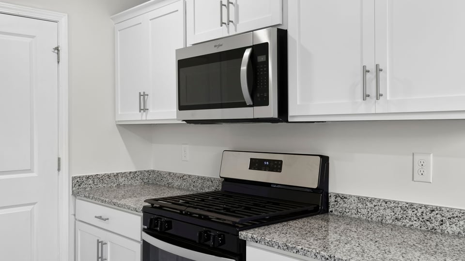 Kitchen and island with quartz countertops.