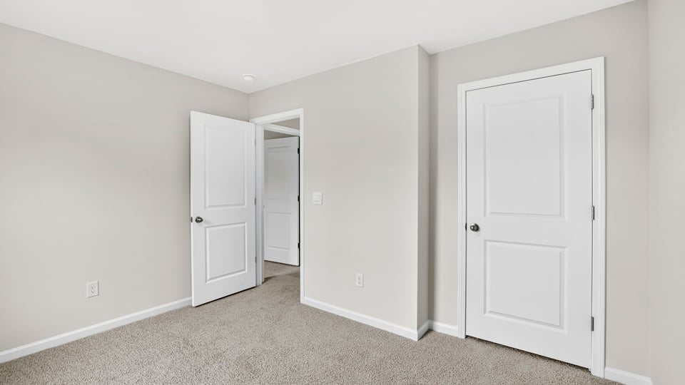 Bedroom with carpet and window.