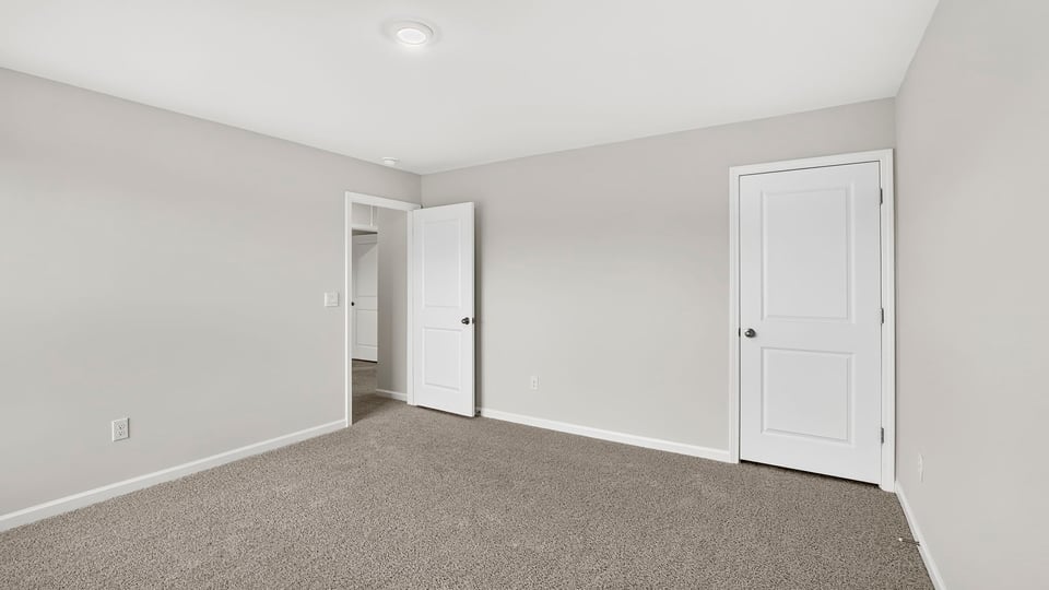 Bedroom with carpet and window.