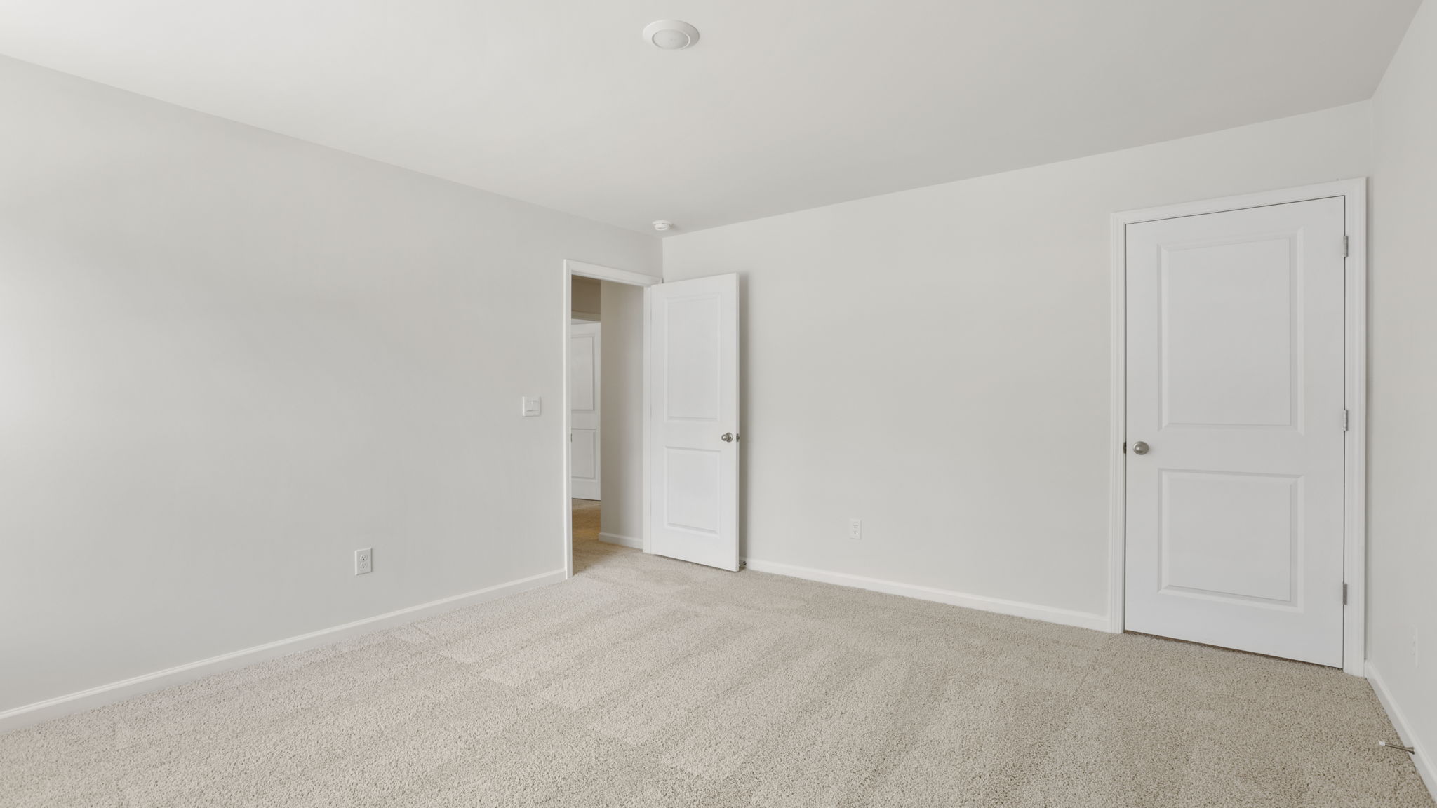 Bedroom with carpet and window.
