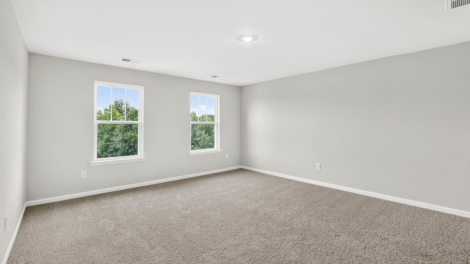 Bedroom with carpet and window.