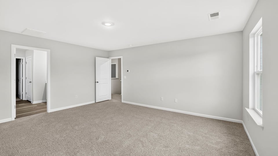 Bedroom with carpet and window.