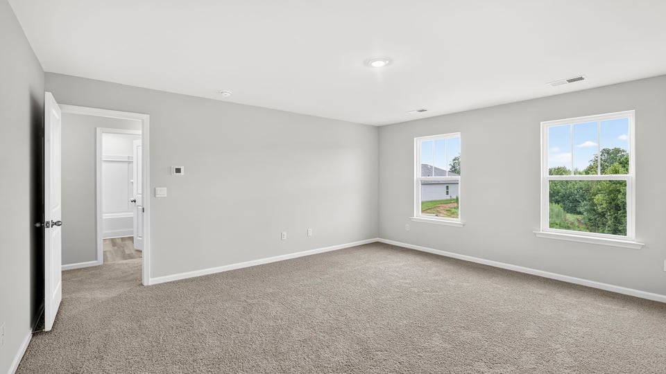 Bedroom with carpet and window.