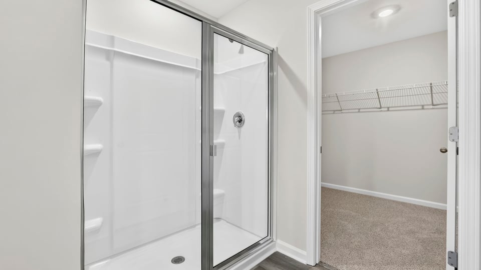 Bathroom with walk in closet and shower.