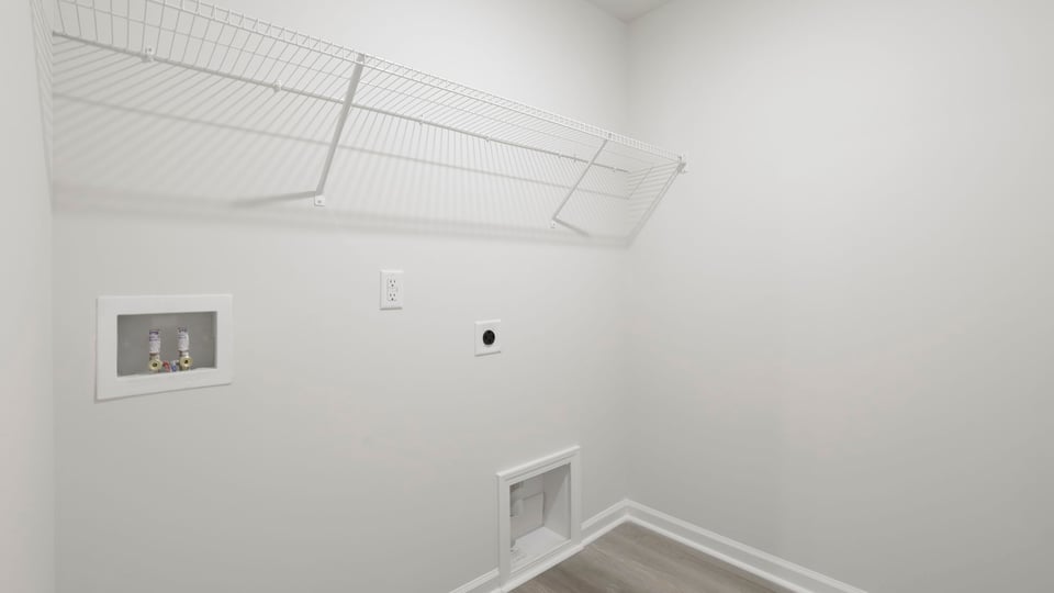 Laundry room with hanging storage racks.