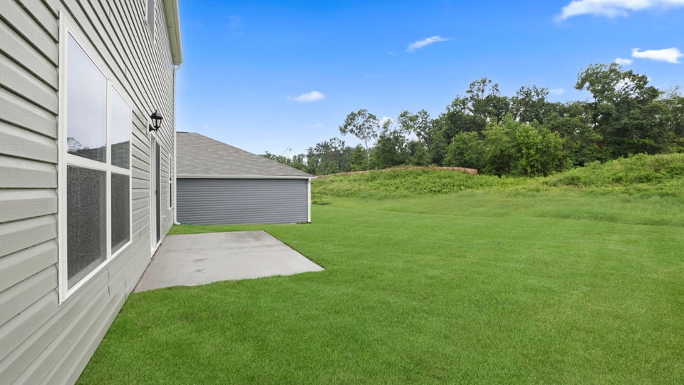 Back exterior of home with patio.