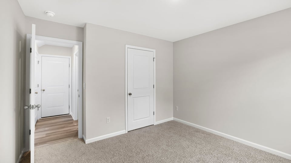 Bedroom with carpet and window.