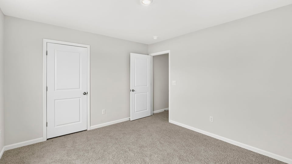 Bedroom with carpet and window.