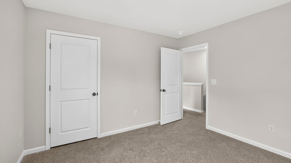 Bedroom with carpet and window.